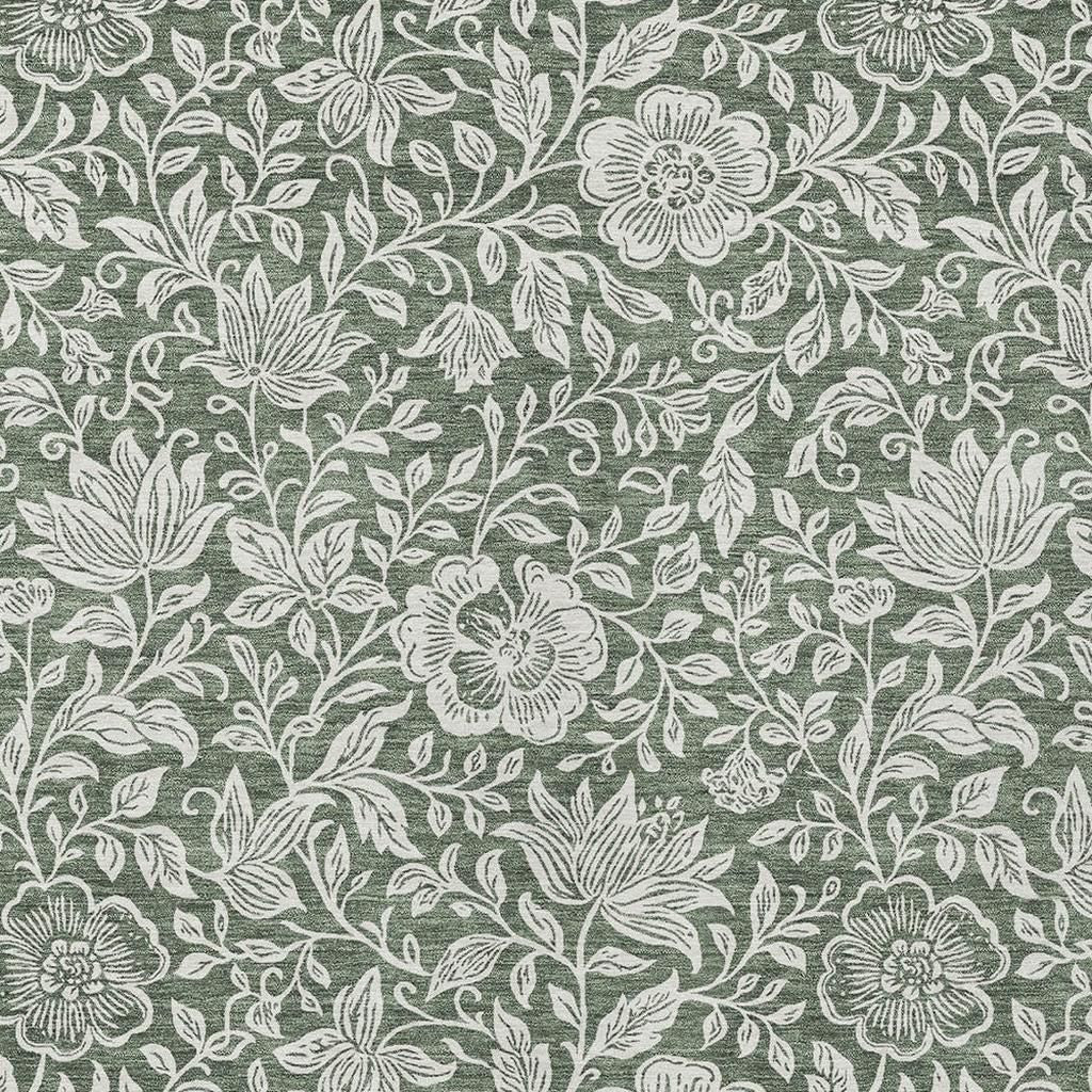 Green rug close-up: ivory blossoms and leafy vines in repeating botanical design.