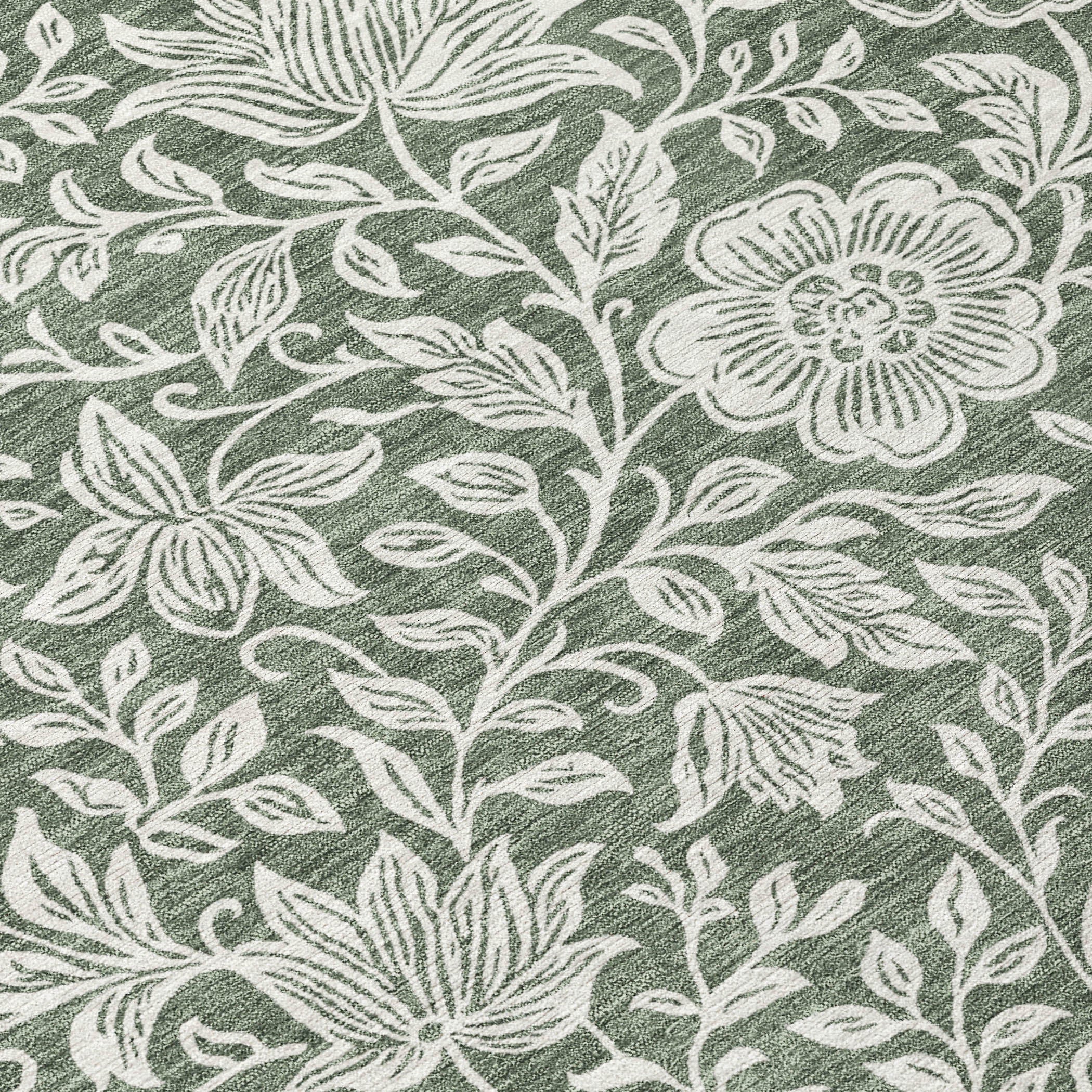 Green area rug with ivory botanical floral vine pattern, textured wash effect.