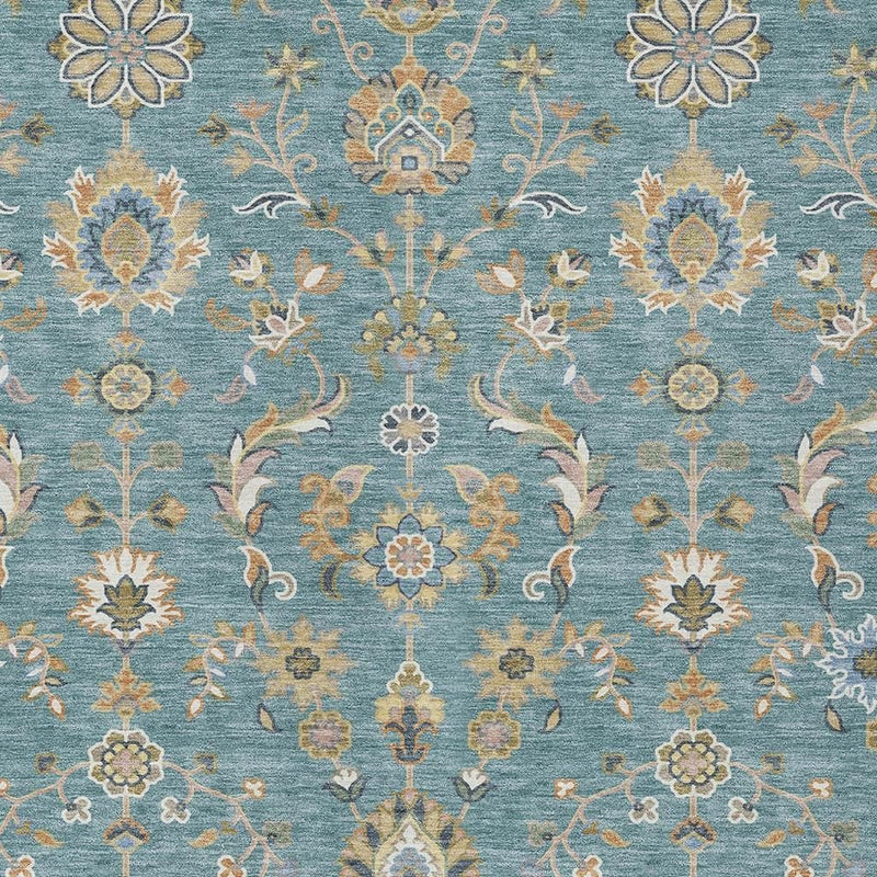 Close-up teal blue rug with ornate cream and taupe floral medallions and vines