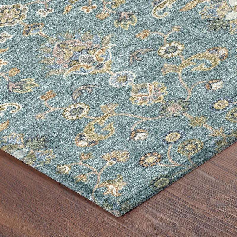 Corner detail of teal blue abstract floral rug with cream, taupe, and orange accents
