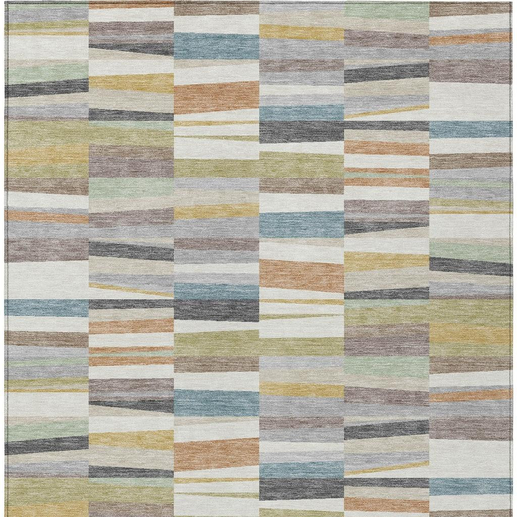 Multicolor striped patchwork indoor outdoor area rug with cream, teal, green, and gray blocks