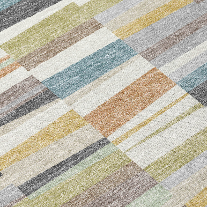 Close-up of multicolor striped rug with teal, olive, gray, tan, and cream patchwork blocks