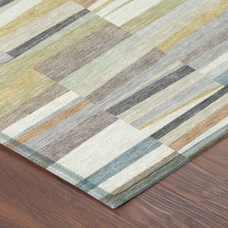 Corner view of striped patchwork area rug with cream, teal, green, gray, and tan tones