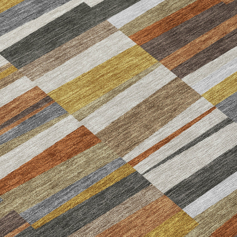 Area rug close-up with diagonal block stripes in gray, cream, rust, and mustard