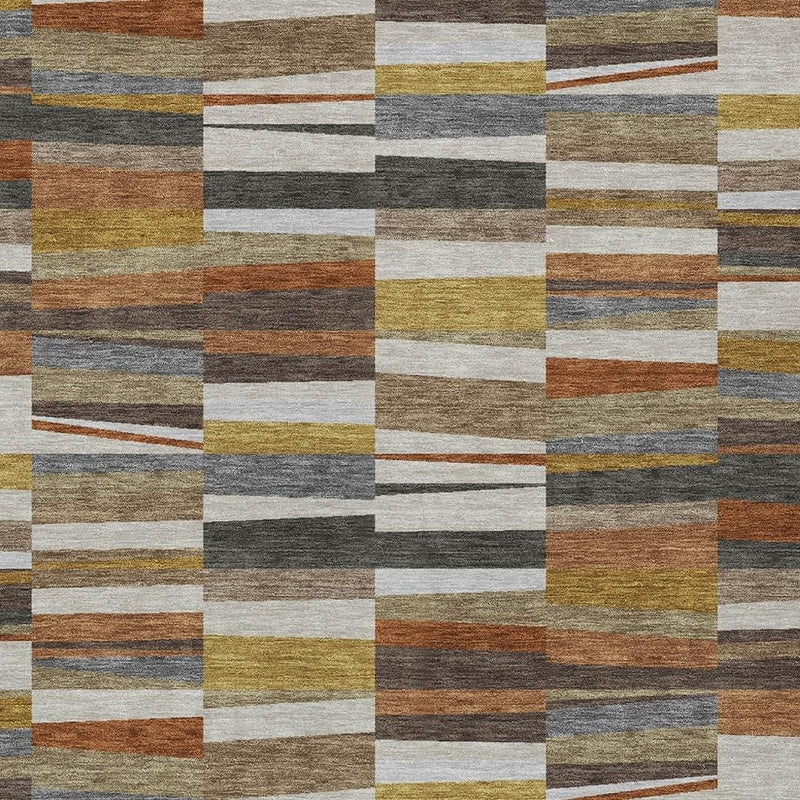 Area rug close-up with muted multicolor stripe rectangles in tan, olive, and charcoal