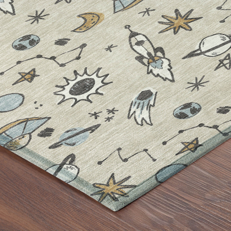 Beige and gray space motif area rug with blue accents, corner edge visible on wood floor.