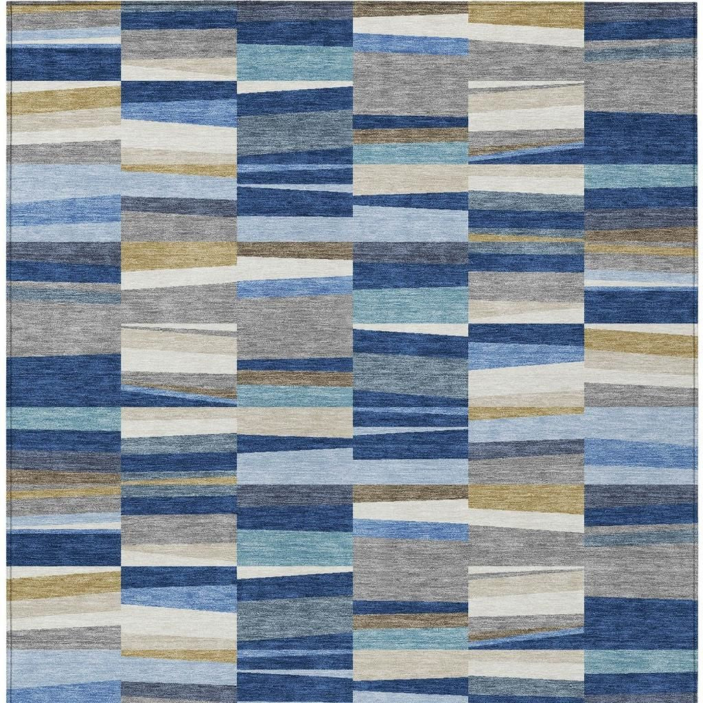 Close-up patchwork area rug showing blue and gray stripes with cream and tan block squares