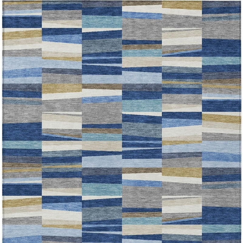 Close-up patchwork area rug showing blue and gray stripes with cream and tan block squares