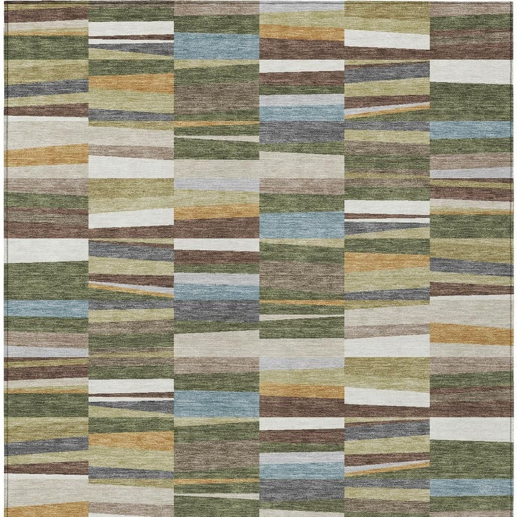 Washable indoor outdoor area rug with patchwork blocks in olive, blue, tan, and white