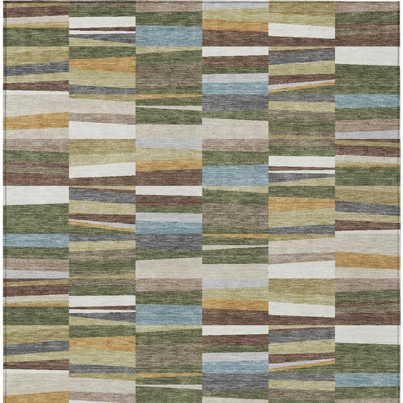 Washable indoor outdoor area rug with patchwork blocks in olive, blue, tan, and white