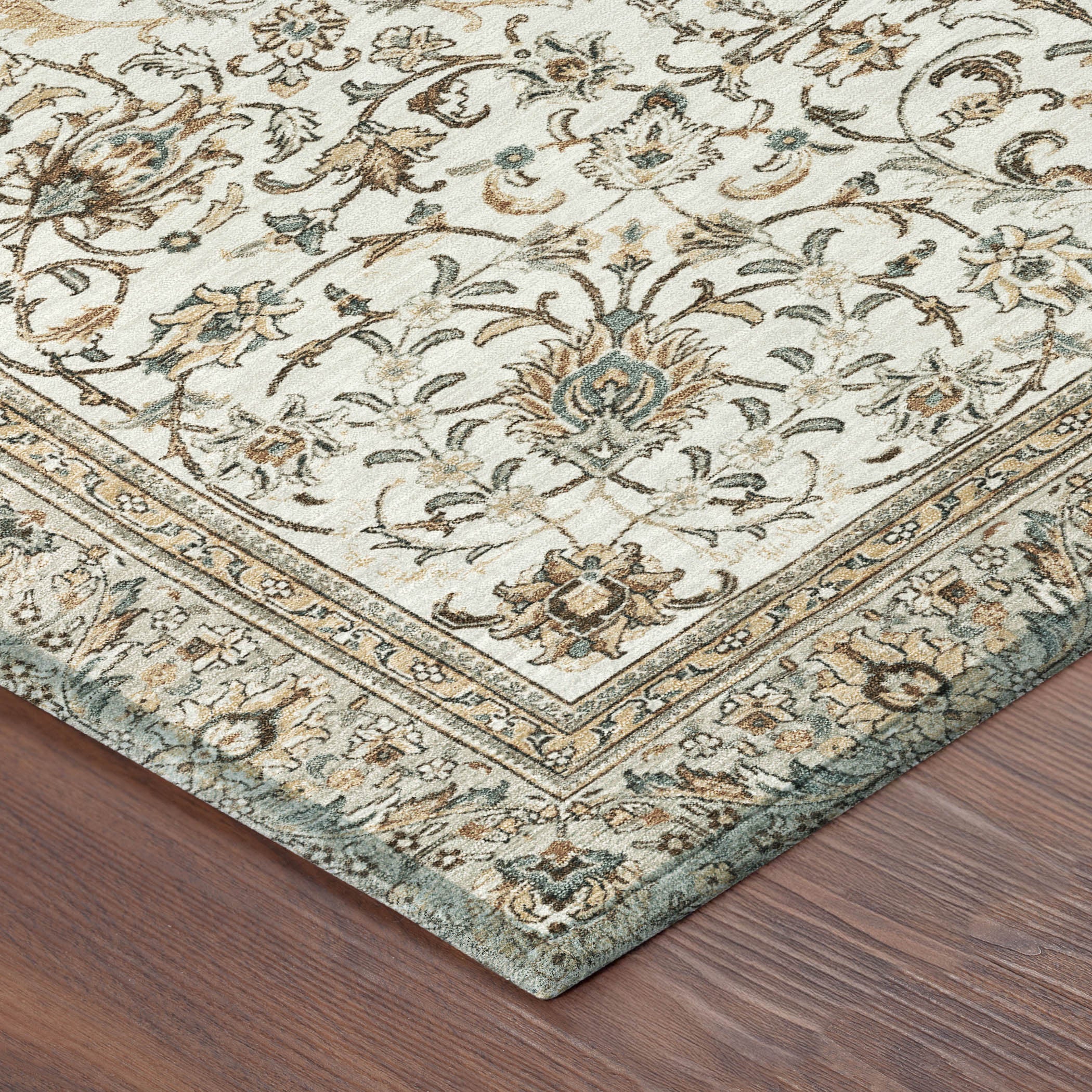 Corner of round rug with ornate border and botanical floral motif on light ivory