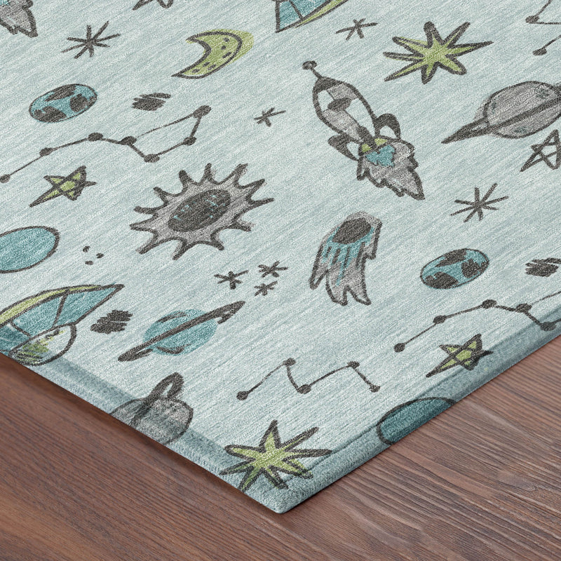 Light blue rug corner with space-animal print and teal binding edge.