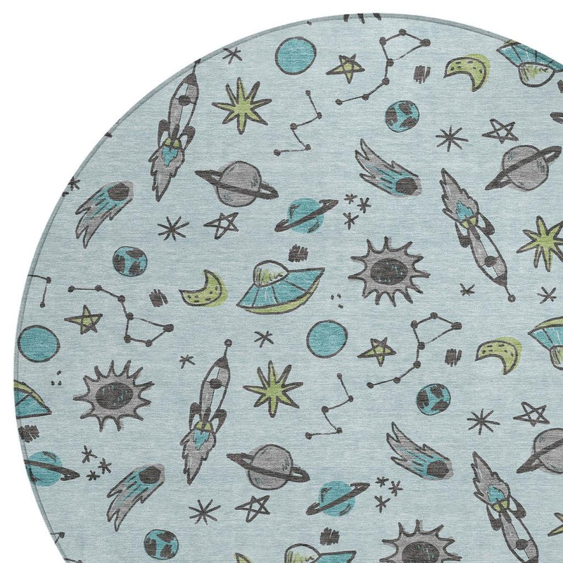 Light blue round rug with scattered planets, stars, and rocket-animal pattern.