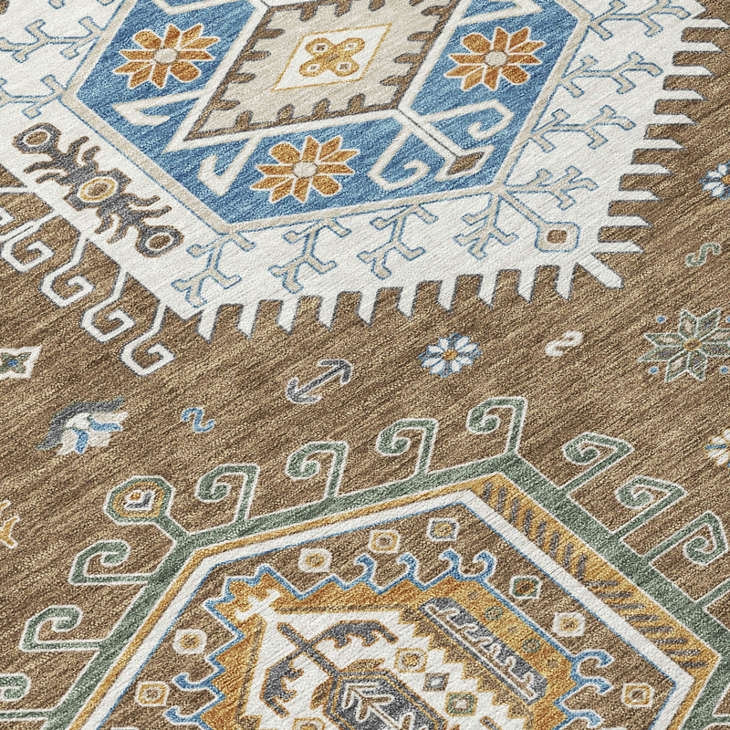 Geometric tribal area rug close-up with blue motifs, tan background, and short fringe edge