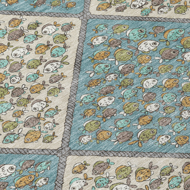 Teal blue and beige area rug corner detail with diamond sections and textured stitched trim