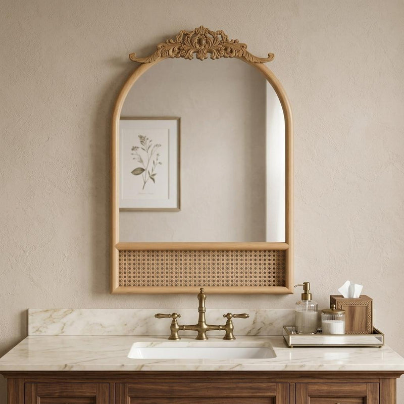 Arched wall mirror with ornate scroll top, brown frame, and perforated rattan base