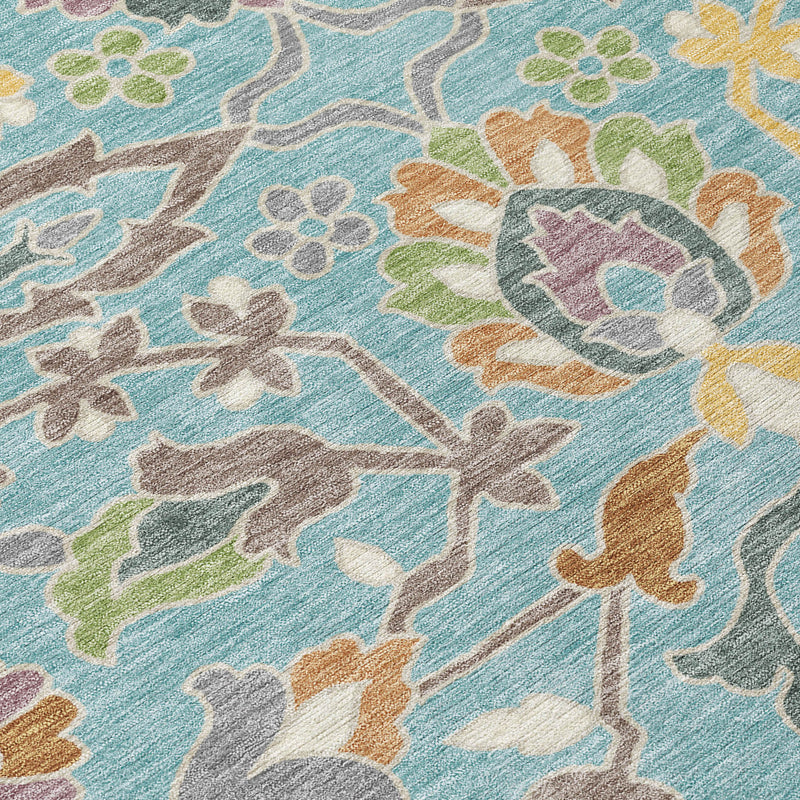 Teal blue floral area rug close-up with multicolor pattern and textured pile