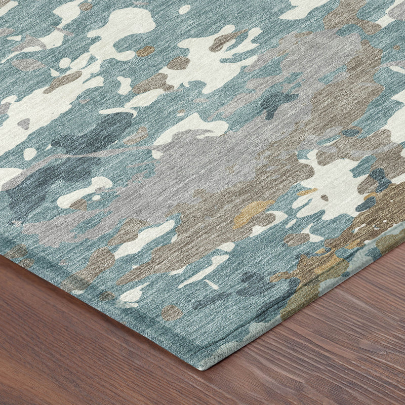 Teal blue and ivory abstract area rug corner on wood floor, distressed print