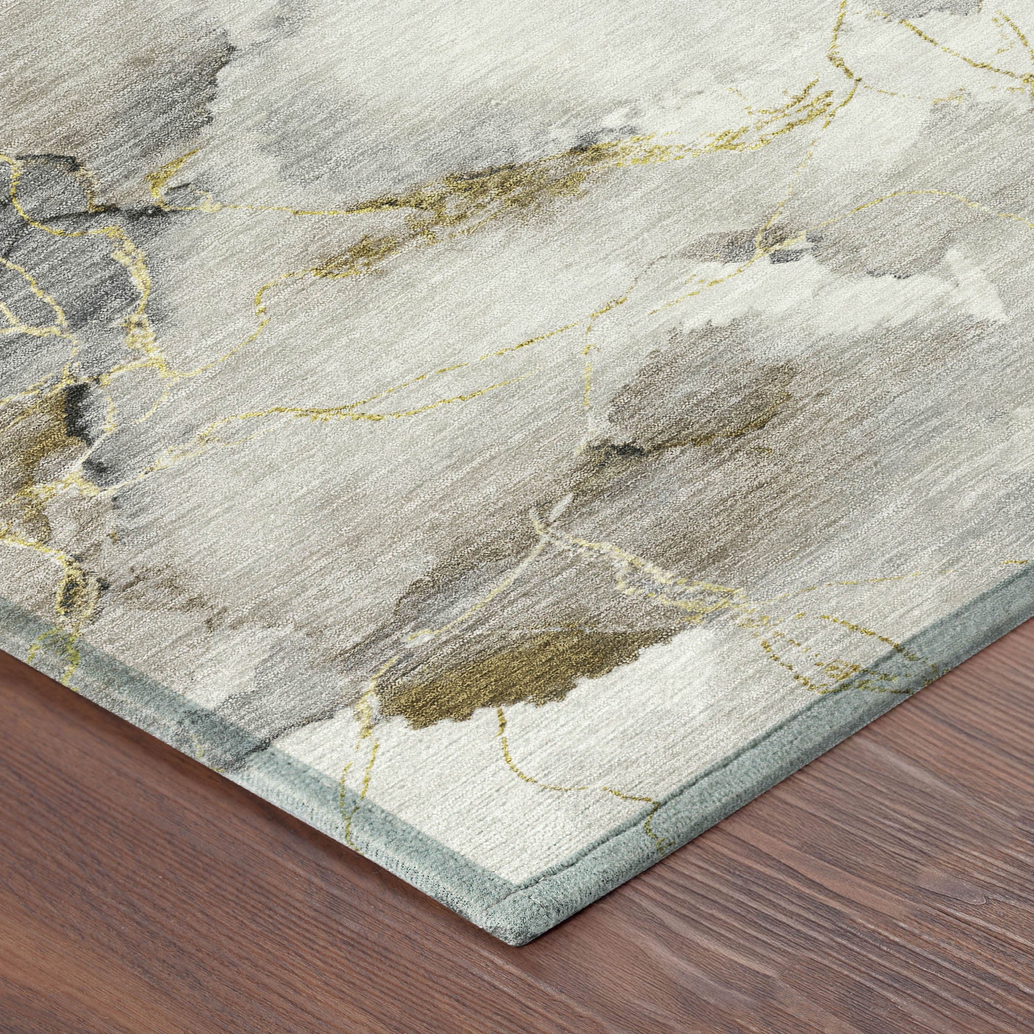 Abstract gray and beige rug with golden accents and a light blue border, perfect for modern home decor.