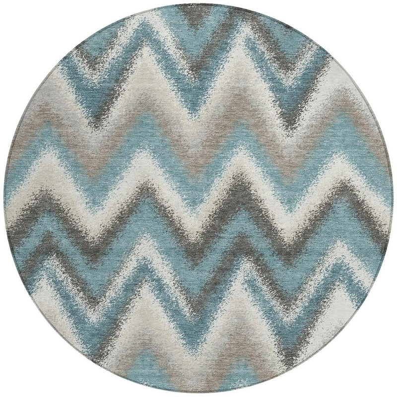 Round washable area rug with teal chevron design and light neutral base