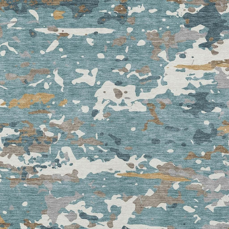 Teal abstract area rug surface close-up with white, gray, and tan paint-like flecks
