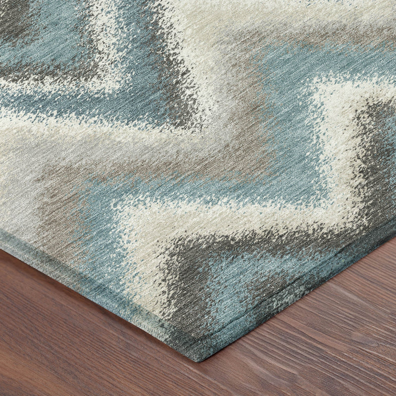 Teal blue geometric area rug with zigzag pattern and distressed texture