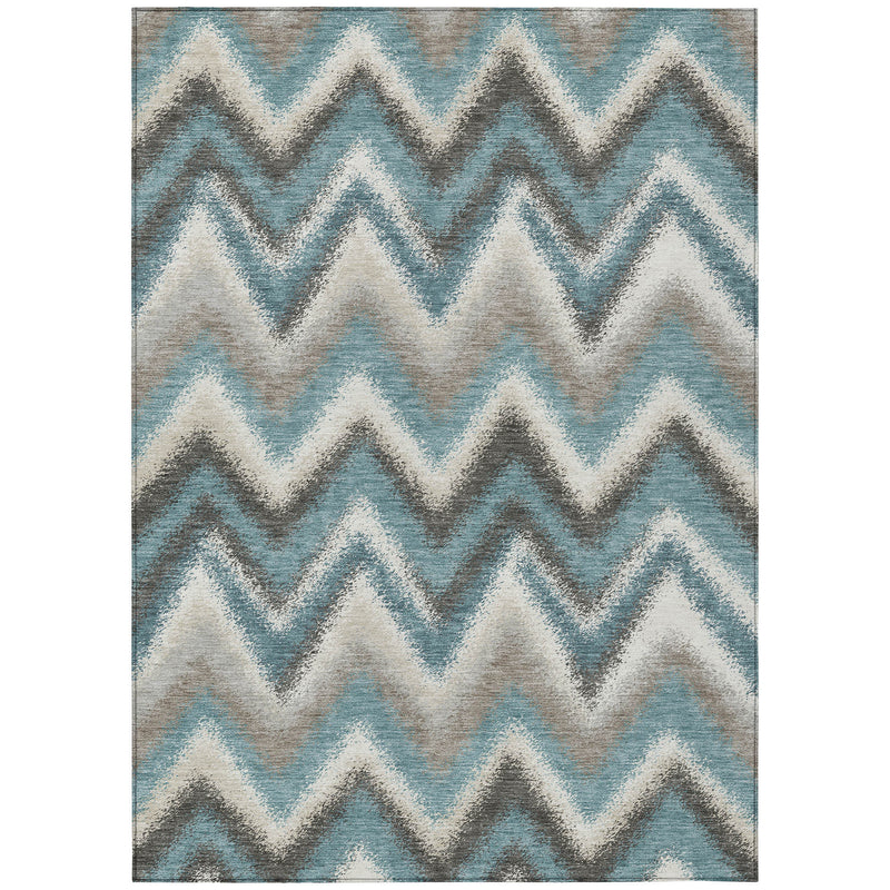 Rectangular area rug with teal blue, off-white, and charcoal chevron zigzag design