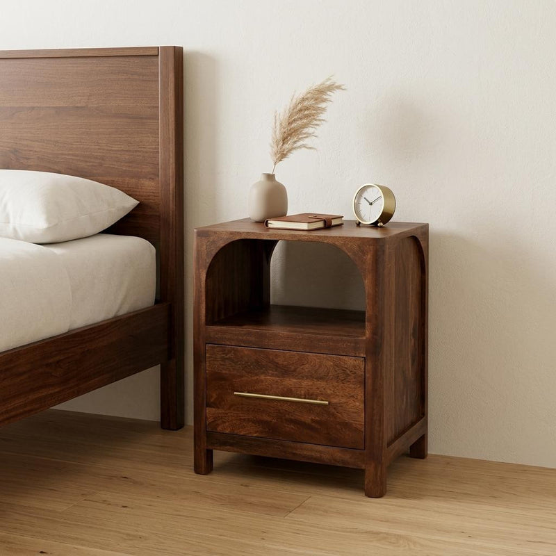 Brown solid wood nightstand with arched open shelf and one drawer, bar metal pull.