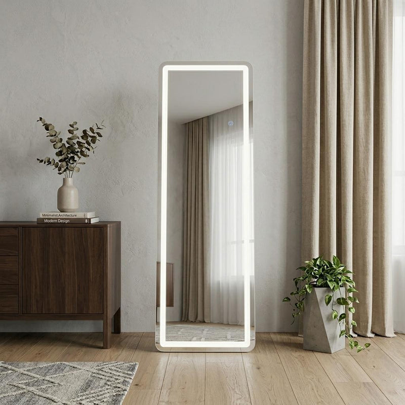 Lighted full-length mirror with white frame, standing upright indoors