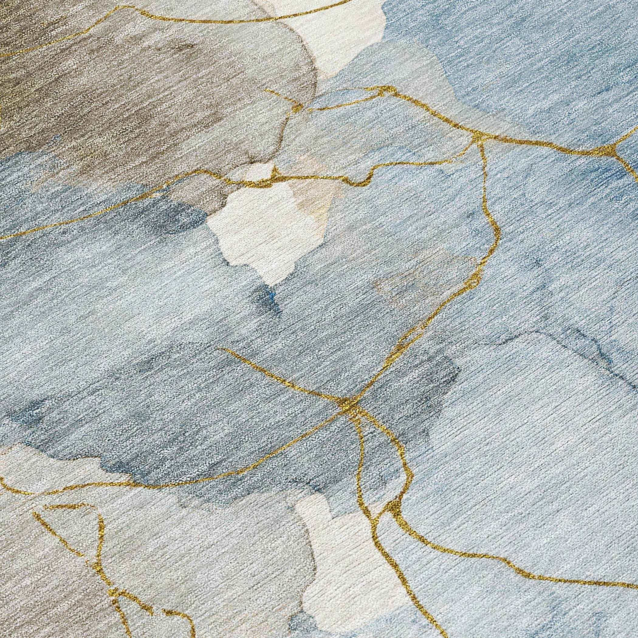 Abstract blue and beige area rug featuring gold marbling, soft textile, perfect for modern home decor.