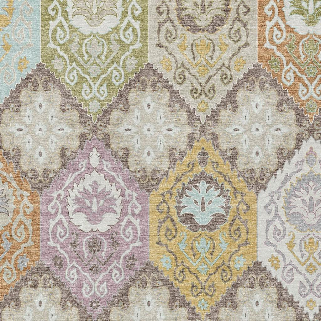 Colorful floral geometric area rug in pastel tones of green, blue, purple, and orange, made from soft synthetic fibers.