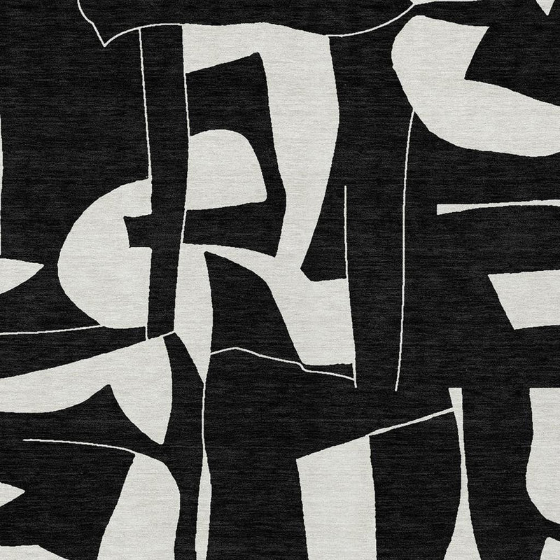 Geometric area rug with bold ivory blocks and black background, abstract linework close-up