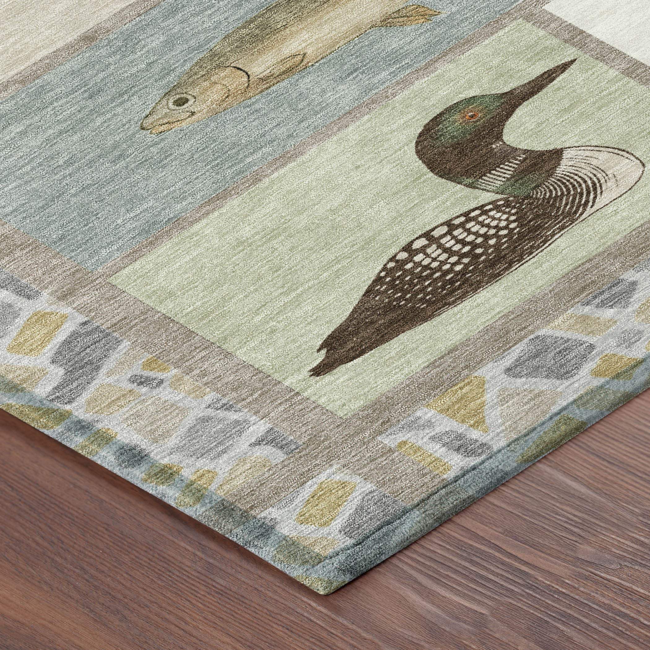 Colorful nature-themed area rug featuring fish and loon designs in green, blue, and neutral tones on a textured background.