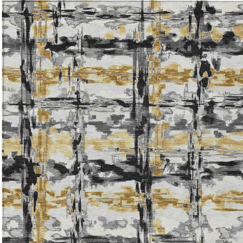 Abstract rug close-up with gray, charcoal, and gold overlapping paint blocks