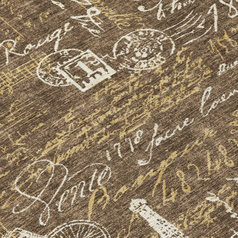 Southwestern area rug close-up, dark brown with white typographic lines and ornate motifs