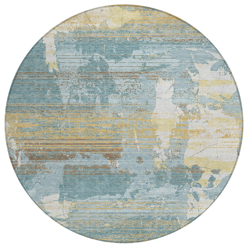 Round abstract indoor/outdoor area rug in teal blue, pewter gray, and pale yellow