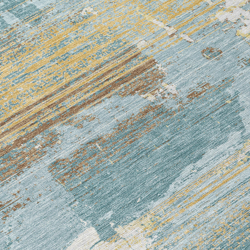 Detail view of abstract area rug fibers with teal blue and gold-beige lines