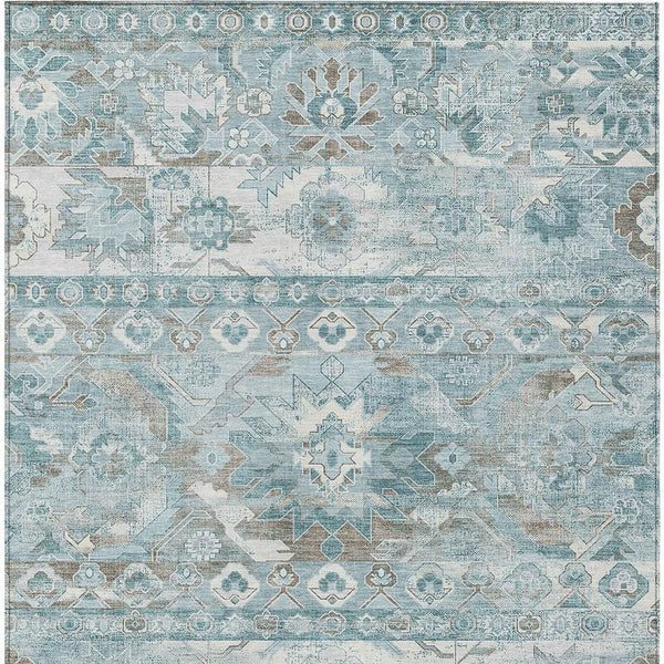 Teal and silver patterned indoor/outdoor area rug, rectangular with border design.