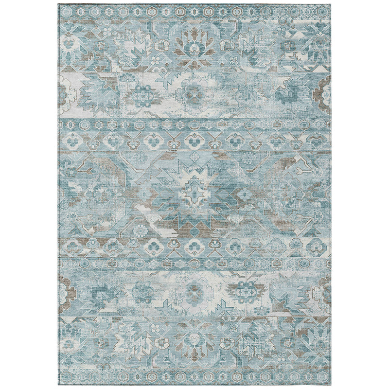 Rectangular teal and silver area rug with distressed global motifs and border.