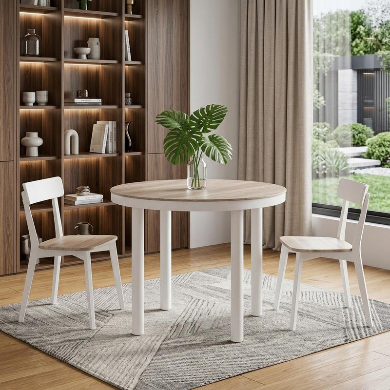 Round dining table with light wood top and white legs in an indoor setting