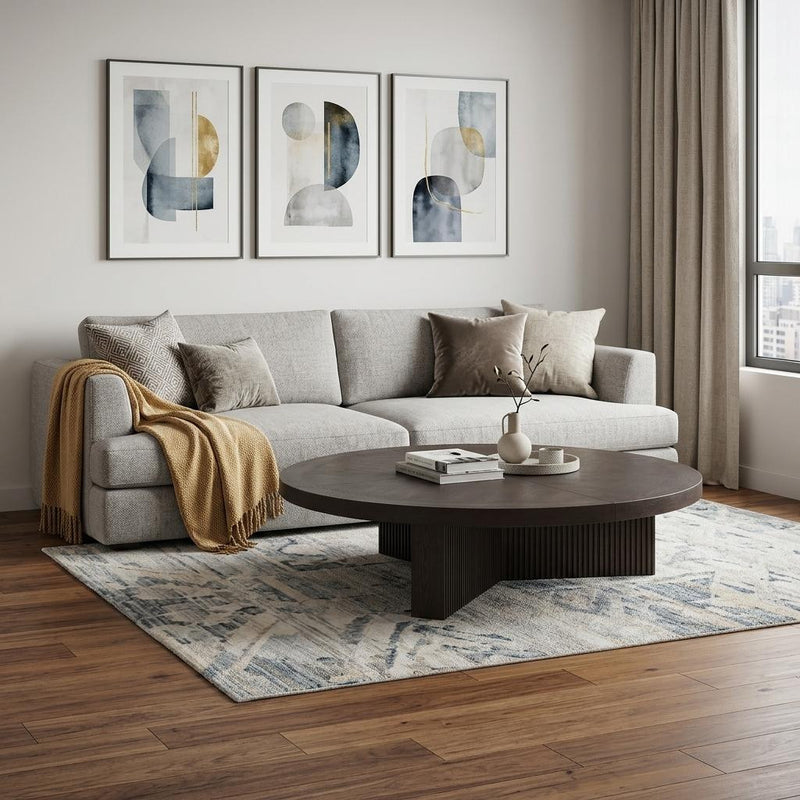 Round pedestal coffee table with dark espresso wood top and ribbed side supports