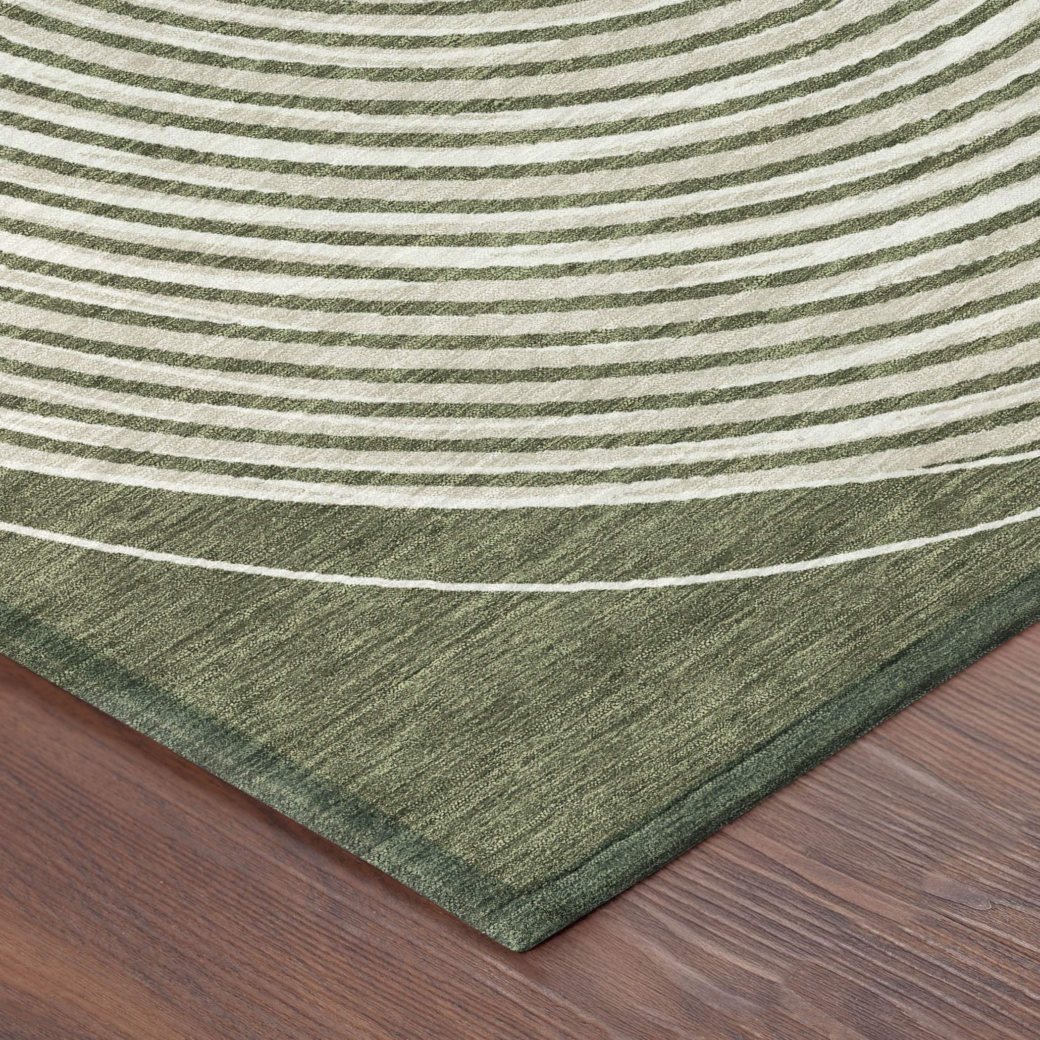 Green striped area rug with a textured feel, featuring a modern circular pattern on a wooden floor.
