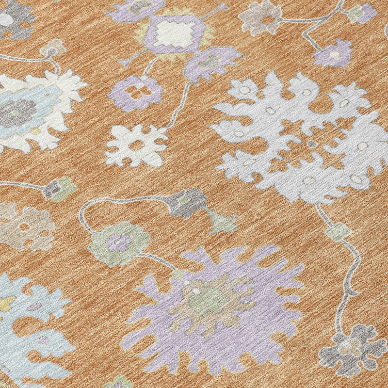 Indoor/outdoor area rug close-up, copper base with light blue floral and lattice motifs