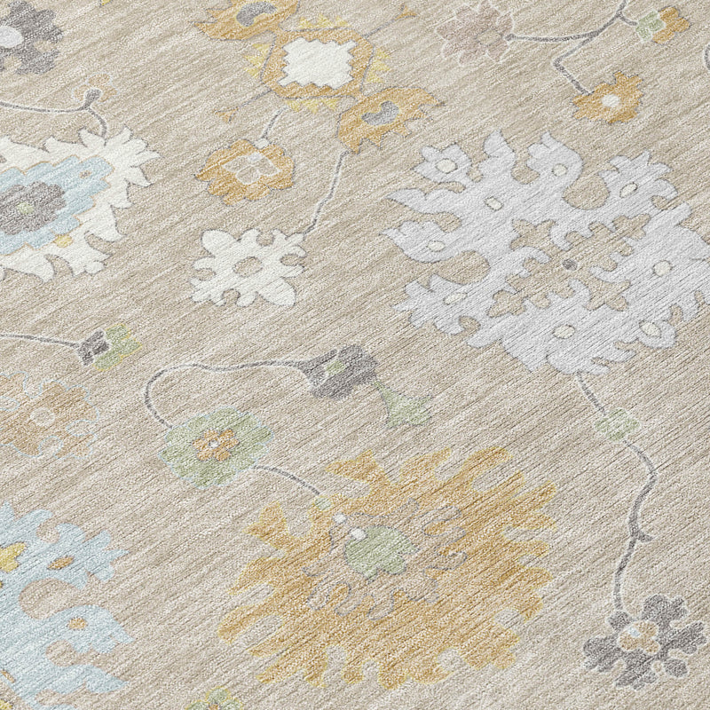 Close-up of round rug fabric with ivory base and stitched-looking gray and yellow snowflake motifs