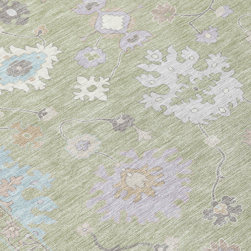 Close-up of round rug fabric: light green with white, blue, and pastel floral pattern