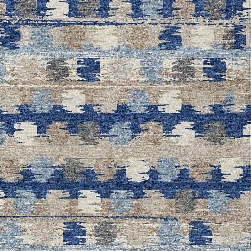 Close-up of abstract area rug with blue and cream distressed block pattern.