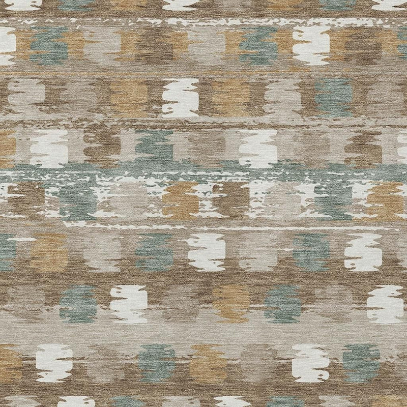 Textured close-up of brown, aqua, and ivory abstract distressed area rug pattern