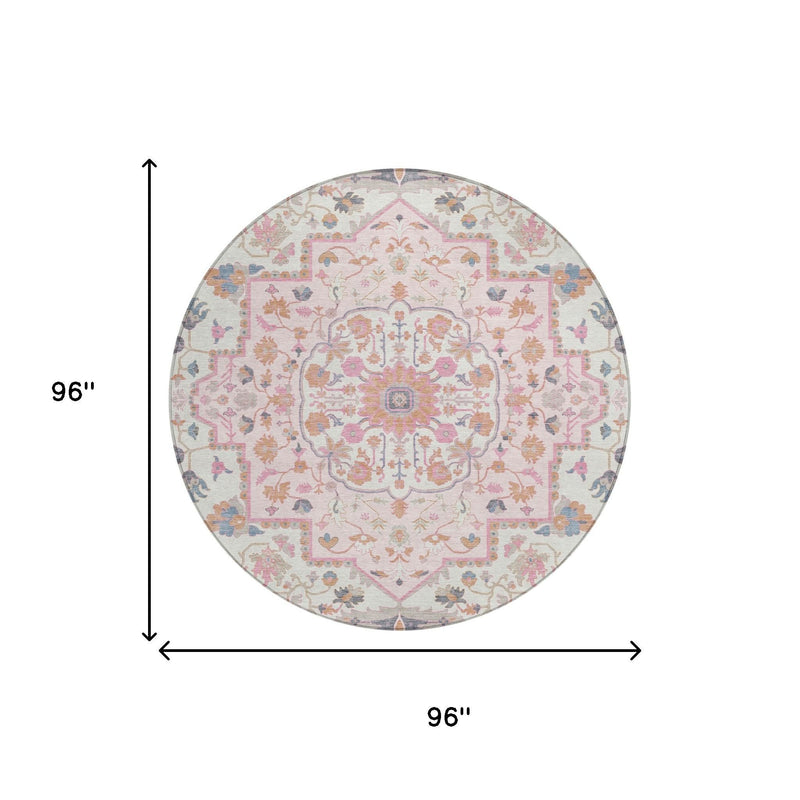 Round oriental rug with cream background and multicolor floral motifs, pink and gray border