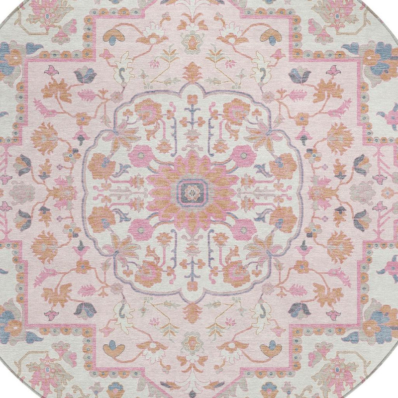 Round oriental rug close-up: cream field with pink, blue, orange motifs and gray edging