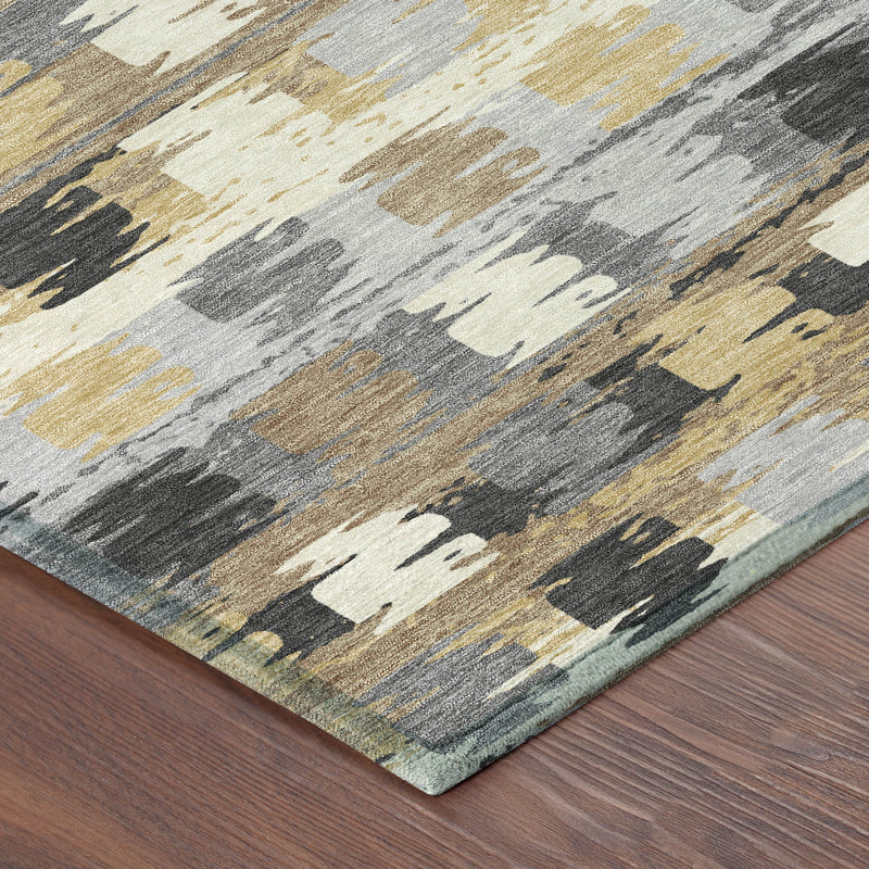 Abstract area rug corner with gray, cream, black, and gold distressed pattern